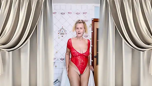 Hot housewife Lukerya changes into a red bodysuit and flirts in the kitchen.