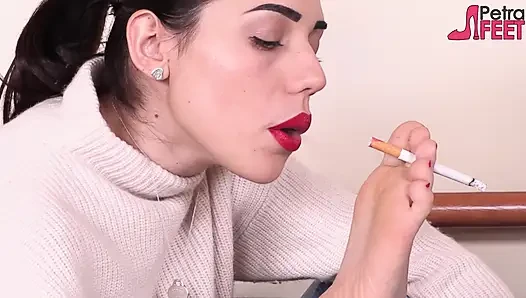 Brunette Petra smokes with her feet