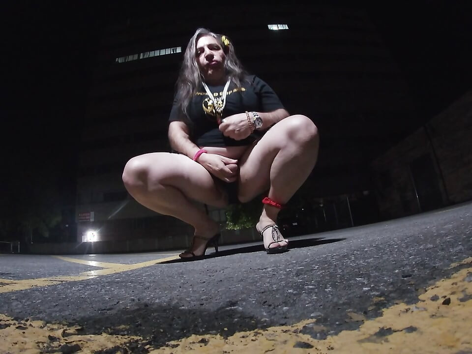 Solo feminized Mature CD goes for a walk in a parking lot