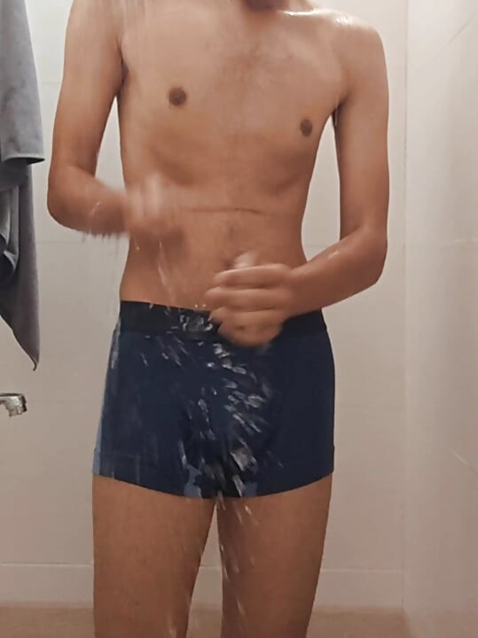 Teen indian boy taking shower