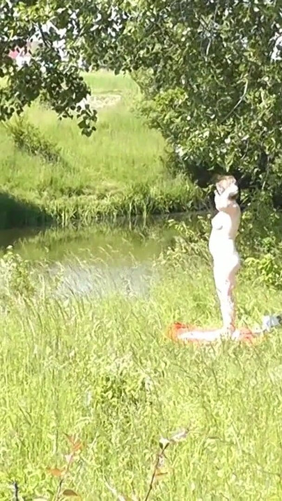 Thrilling moment from "Milf sexy woman sunbathing naked on river bank. Naked in public. Wild beach Nudist. Ass. Pussy."
