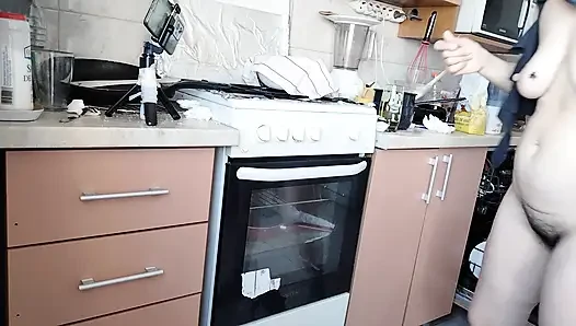 Sexy wife prepares lunch naked in the kitchen.