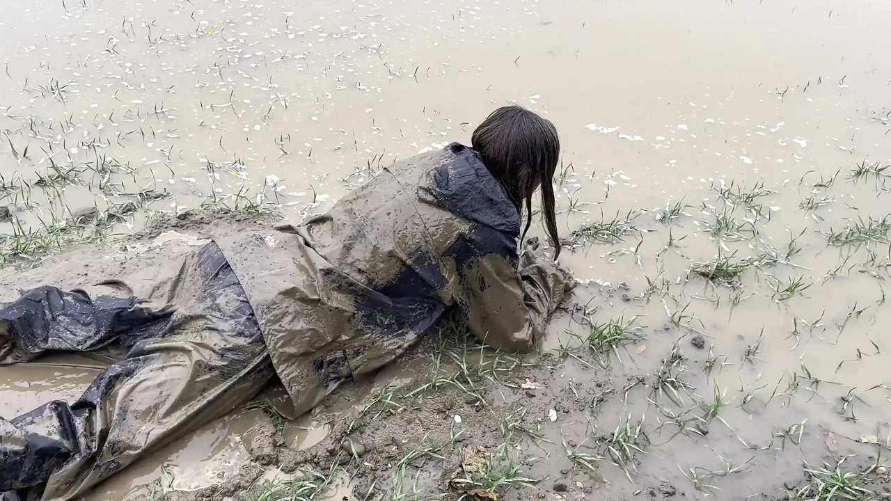 Muddy fields, rain suit in the rain