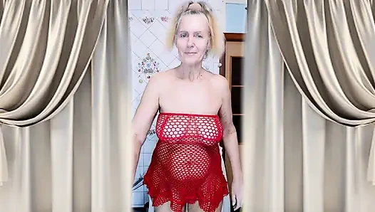 Hot housewife Lukerya in a red mesh dress flirts and makes coffee in the kitchen.