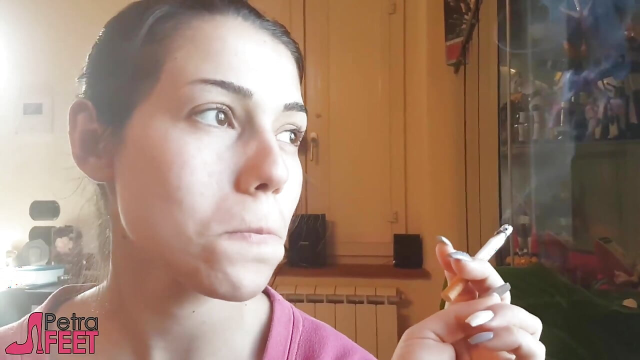 Tempting Italian girl smokes a cigar in a close up video