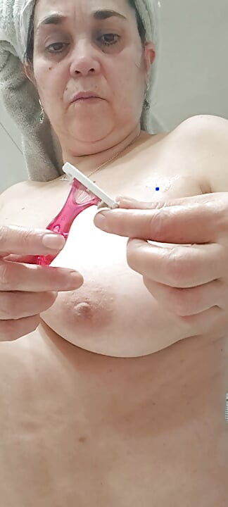wife removing some hair from her armpits