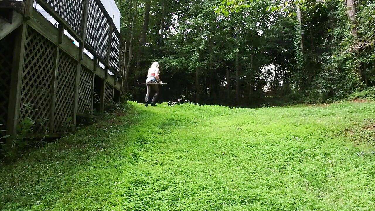 Big Fake Tits Crossdresser in Daisy Dukes Mowing Grass