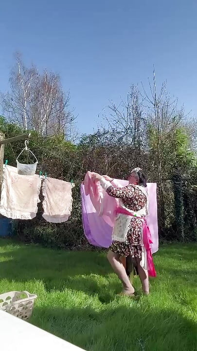 In maid gardener outfit to hang the laundry