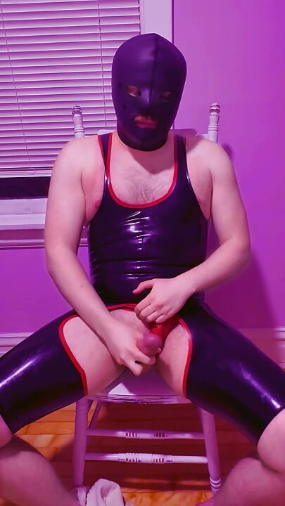 Playing with myself in my rubber chapsuit and thong