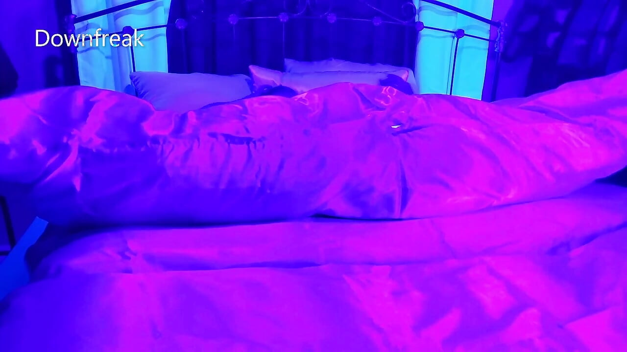 Siyah ışık altında saten yatakta sikişiyor