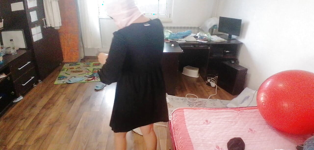 Amateur woman has fun trying on clothes and cutting them.