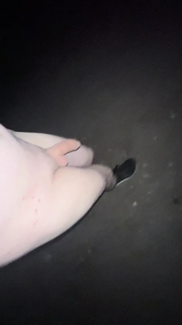 Young boy walking naked outdoors