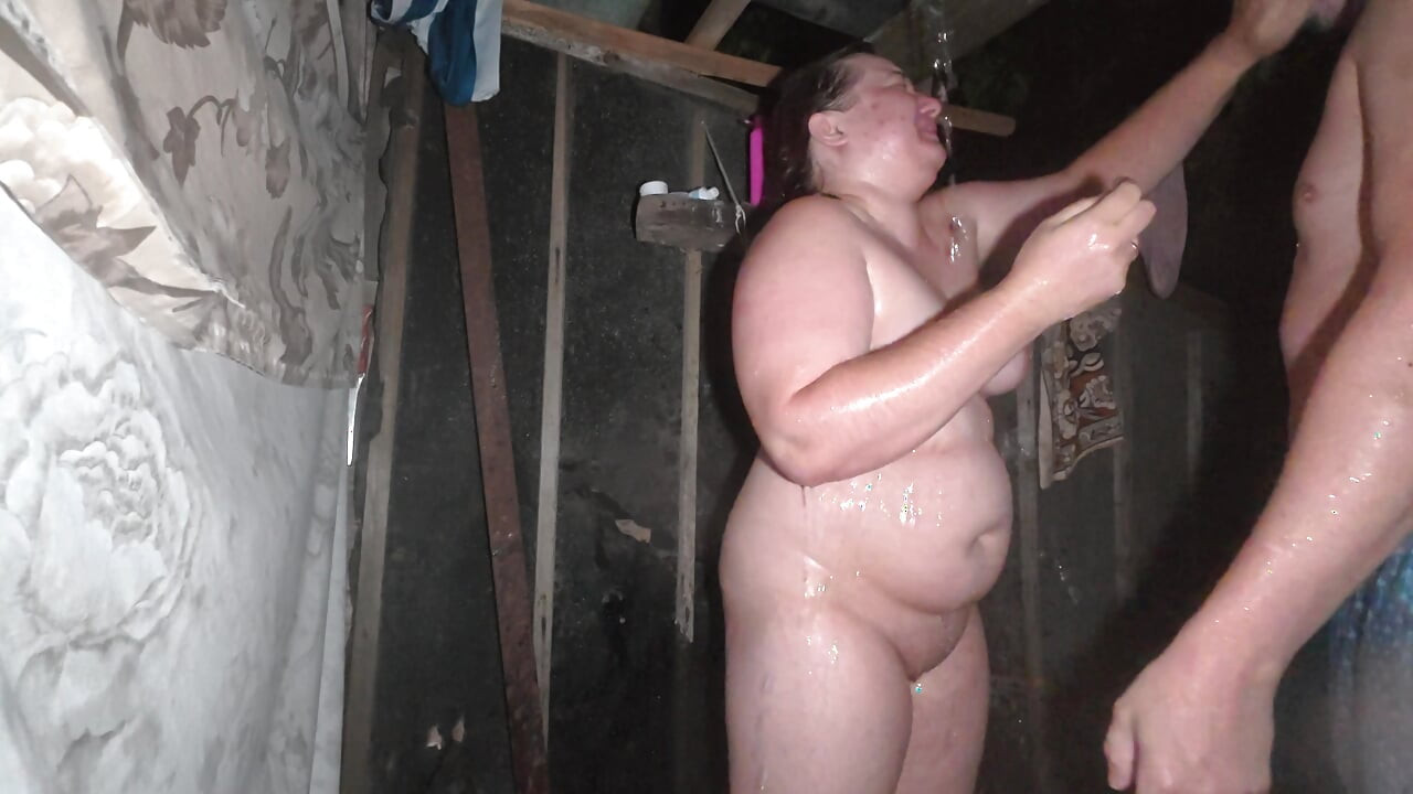 Golden shower at night in an outdoor shower