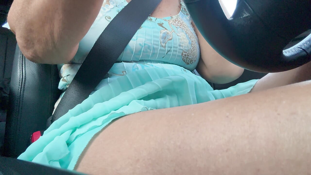 An elegant lady drives to work and rubs her pussy with her hand between her hot thighs