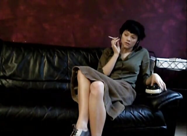 Black haired teen smoking a cigarette