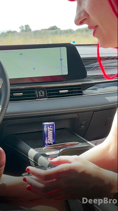 Redhead deepthroats thick BBC in the car, fingers gripping tight