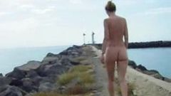 Firm titty gal takes a nude walk by the ocean.
