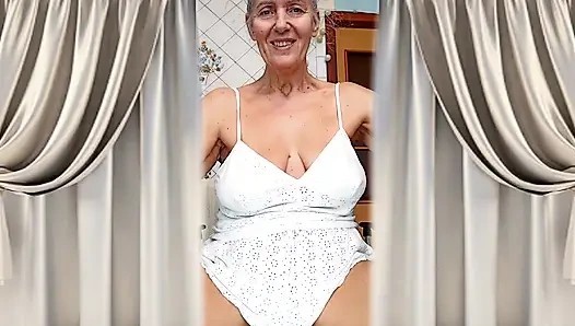 Lukerya ibu rumah tangga yang ceria. Rambut perak yang mulia dan cahaya yang nyaman di kaki telanjangnya.