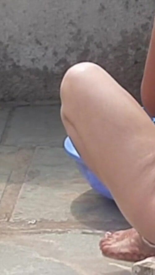 In the country's bathroom of the village, the elder sister-in-law's stepsister is soaking her saree in water and bathing naked in the open. | Clip 3