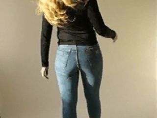 Slim girl walking in skintight blue jeans and highheels 2