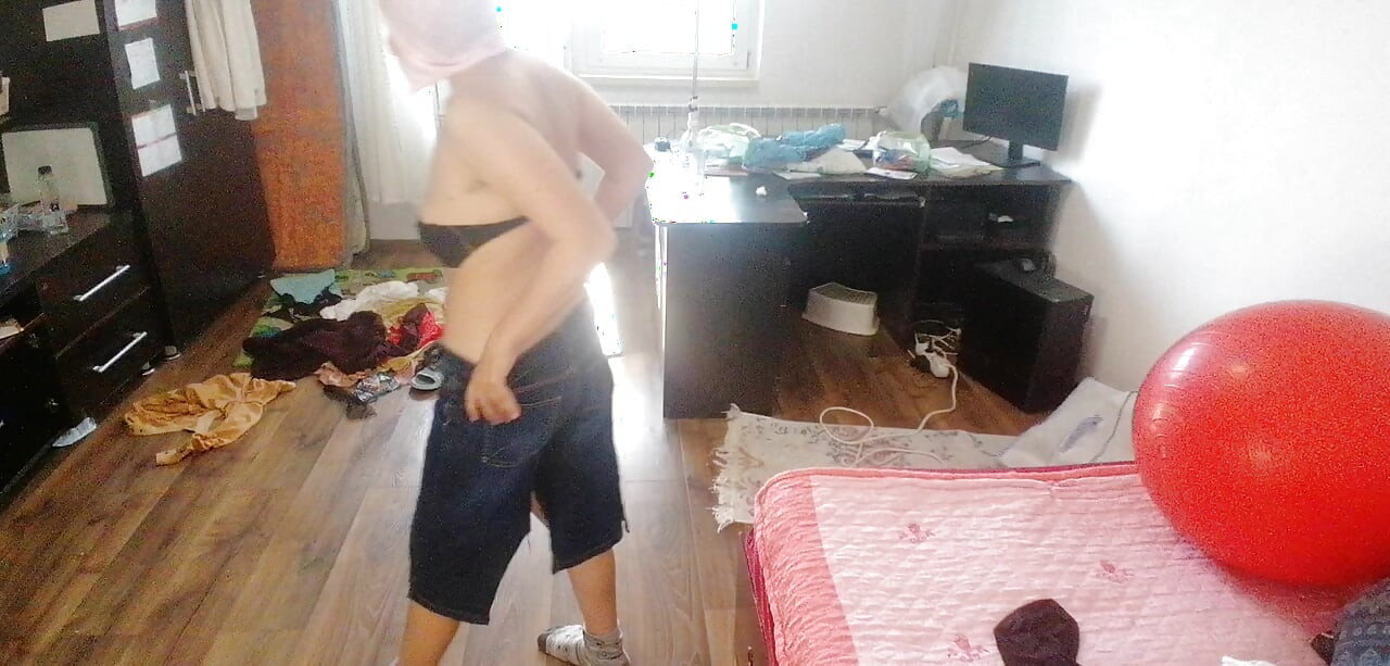 Amateur woman has fun trying on clothes and cutting them.