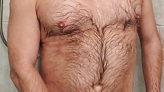 Tanned hairy daddy soaps up and cums in the shower
