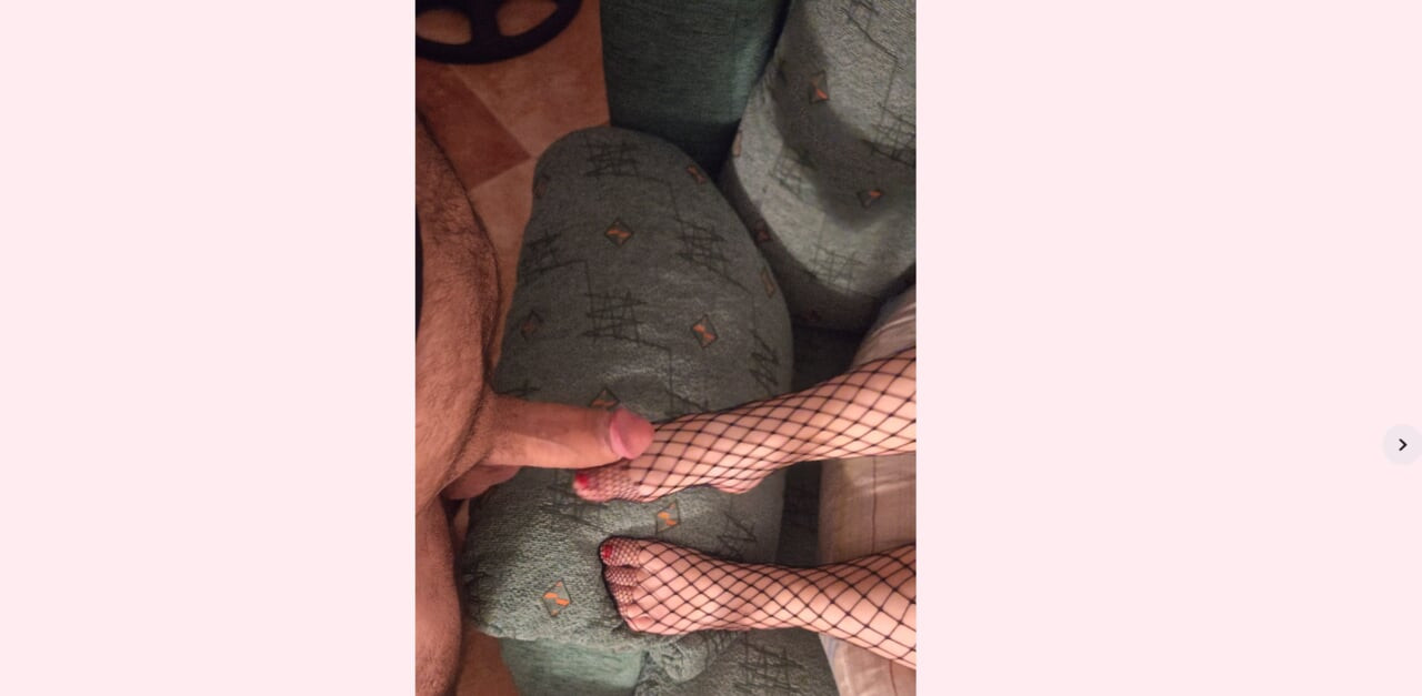 giving a feetjob with black fishnet stockings