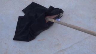 sweeping concrete with black pencil skirt