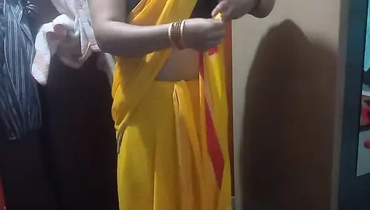 Indian housewife is wearing a yellow saree.