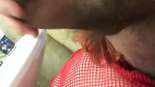 Mature redhead gives a good blow job in the bathroom