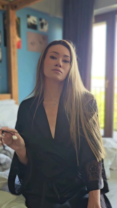 Hot asian woman with glasses in silk robe