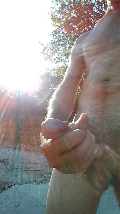 Unexpected seclusion in nature leads to naked man stroking in the sunshine