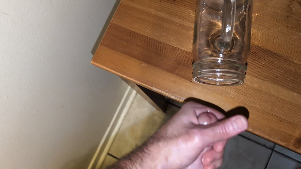 Fat man jerking his hard cock and cumming in a glass