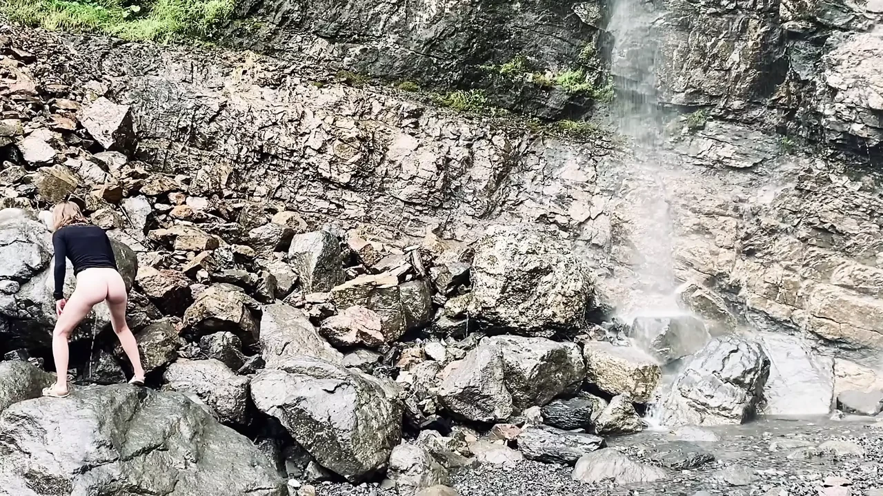 Young teen piss next to warerfall