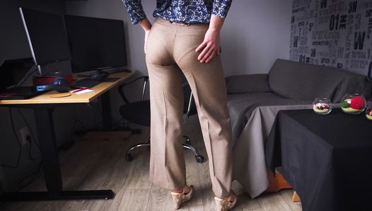 Une secrétaire sexy taquine la ligne de culotte visible dans un pantalon de travail moulant