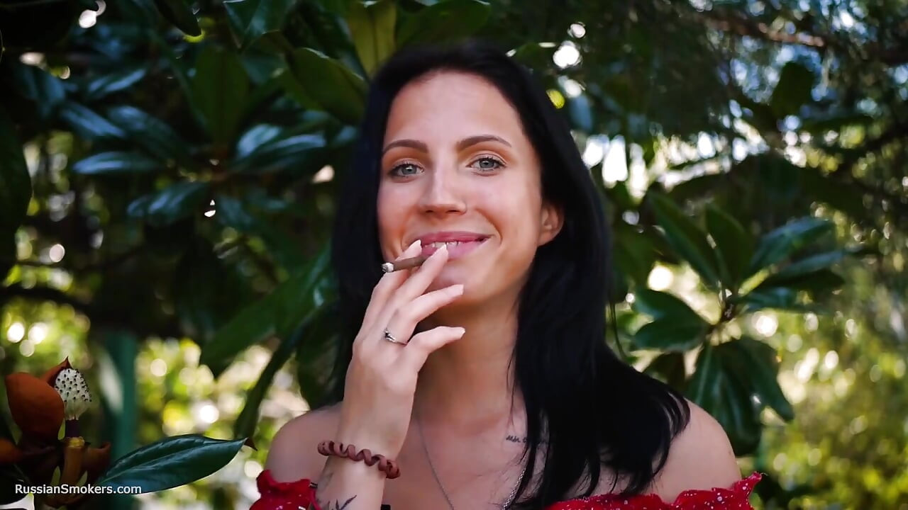 Sultry Brunette in Red Dress Smoking Rolled Cigarette