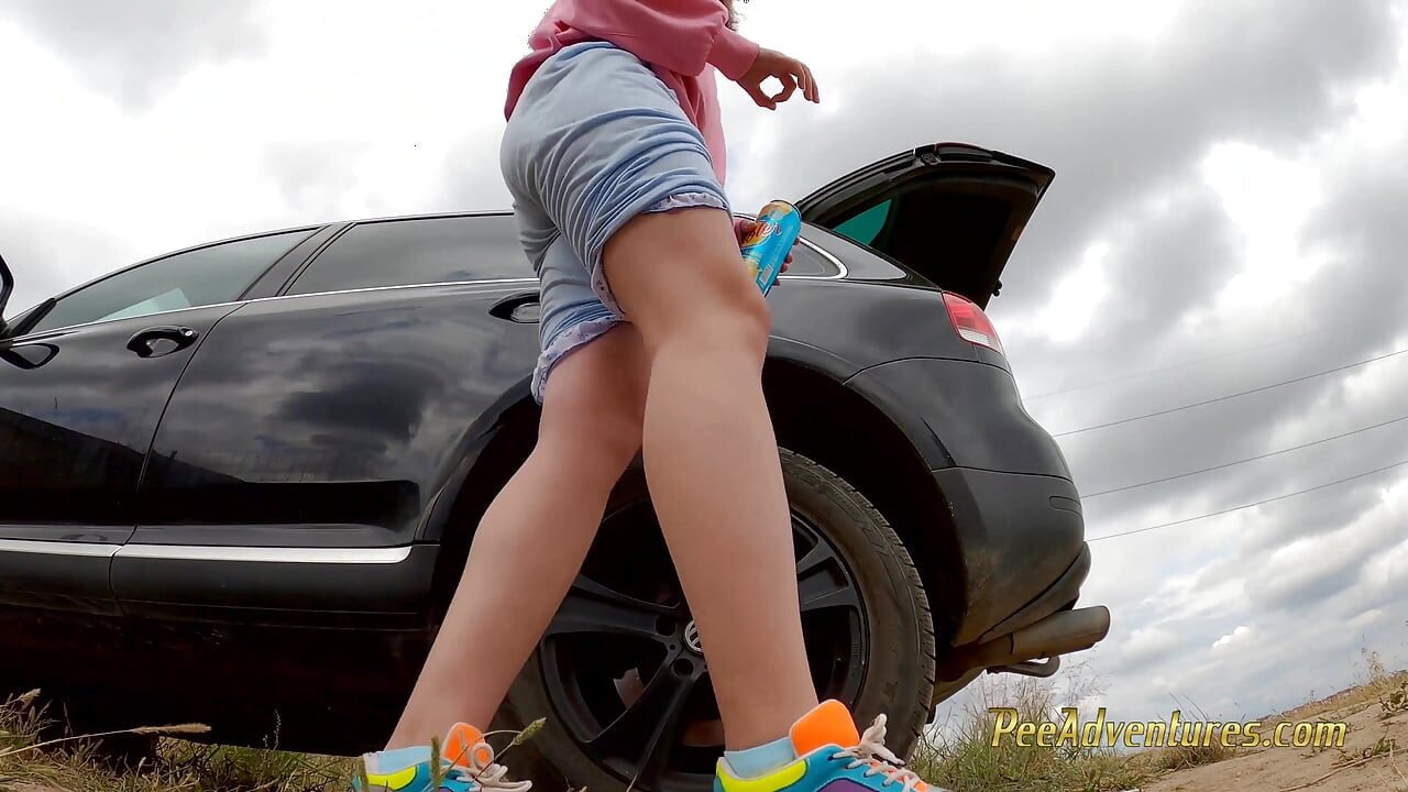 Hipster girl pee with her legs wide opened outdoor