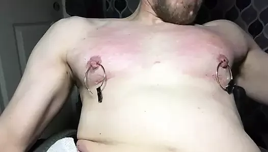 Clint Cumin- disabled submissive stretches nipples, clamps , and whips chest.