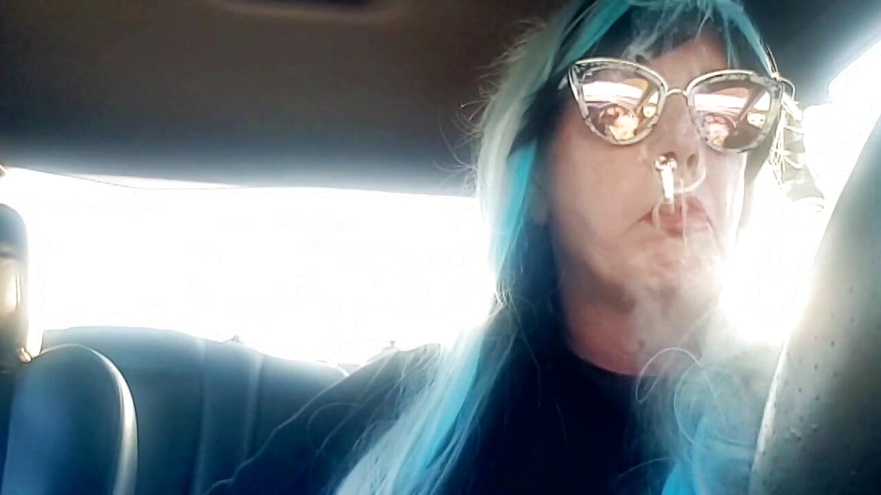 MATURE CD SMOKING & DRIVING WITH A MB100 CIGARETTE IN HER GLOVED HAND