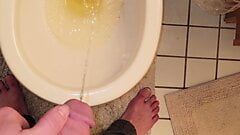 Twink emptying very full bladder in toilet