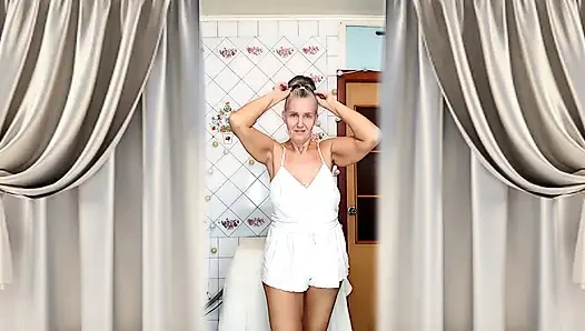 Real home solo of a mature woman in a small cozy kitchen.