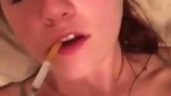 Smoking brunette brings herself to orgasm