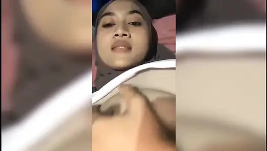 Beautiful girl who is squeezing her breasts alone