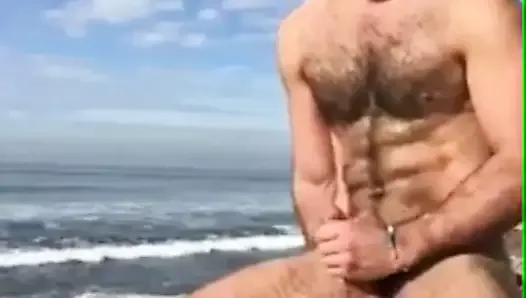 Hairy gay jerks off at the beach