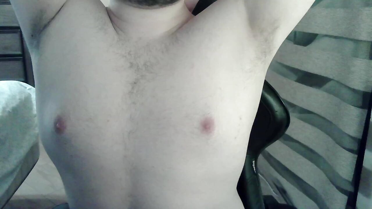 Muscular camboy flexes his muscles and squats