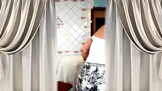 Cheerful housewife Lukerya in a homely atmosphere in the kitchen.