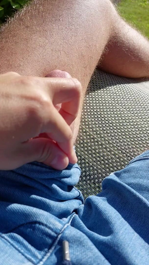 Massaging big cock bulge through pants in the garden