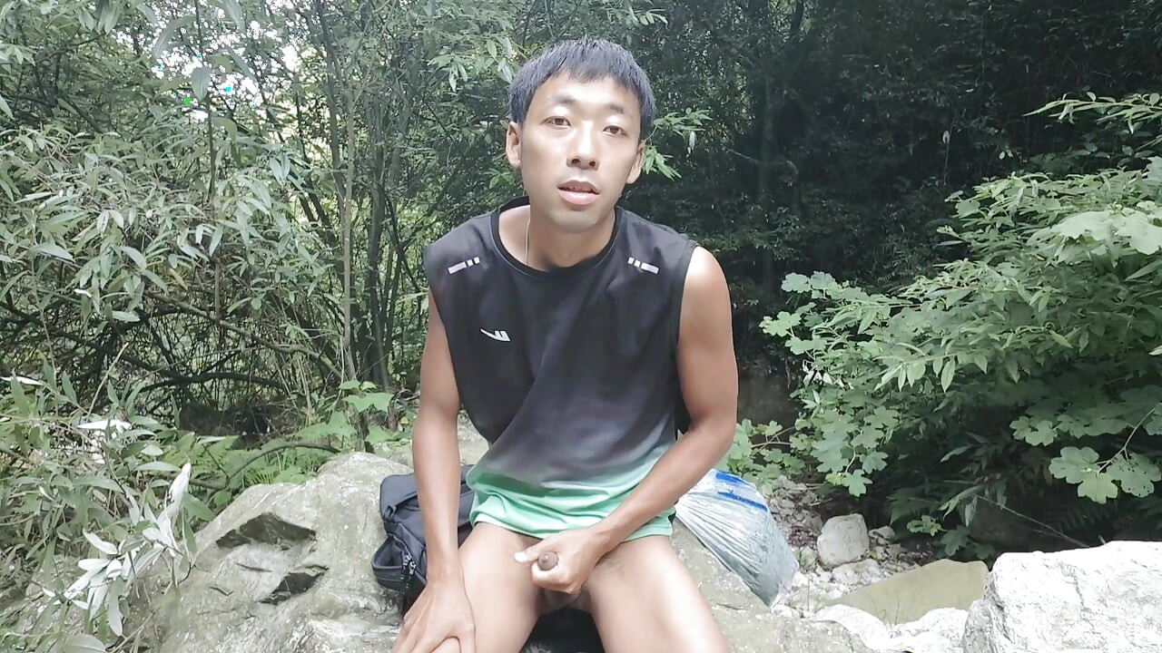 A wild boy masturbates, moaning and ejaculating by a stream in the deep mountains, and then eats his own semen