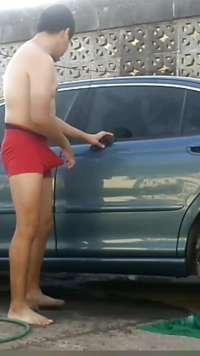 Jesus in red boxer washing his jaguar car