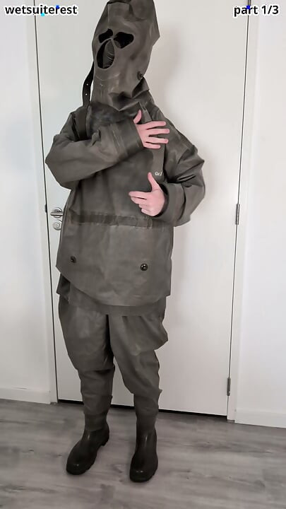 Putting on Zodiac Zodiak heavy rubber hazmat suit over plastic pants and gas mask